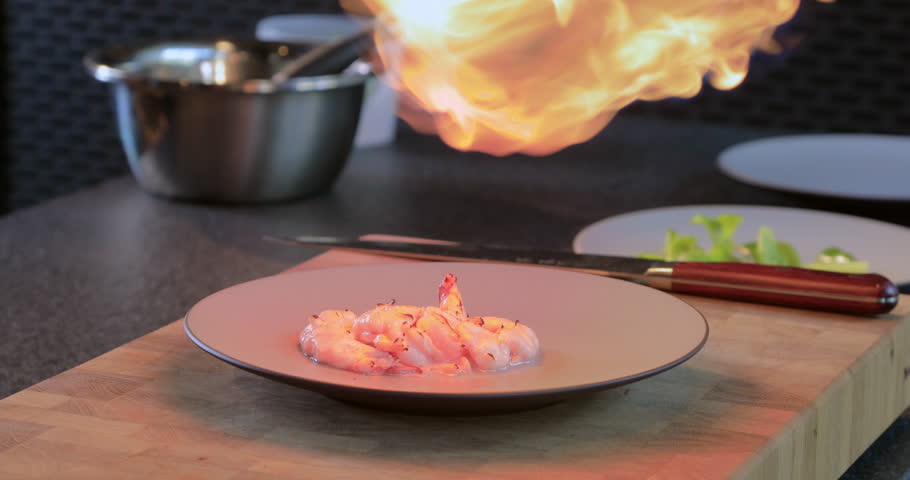 Seafood on an open fire. We fry the king crab with a gas burner.Cooking shrimp. Grilling shrimps on an open fire Seafood.
King prawns is scorched with gas-burner. Fire spray of gas burner in chef hand | Shutterstock HD Video #1098416729