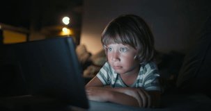 Close up boy 4-5 years afraid child using tablet in living room, Small child hold pad computer surfing not safe content online internet at home concept safety parental security child on social media