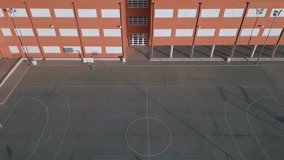 Aerial drone shot over playground and school building on a sunset time. Education in Spain theme.