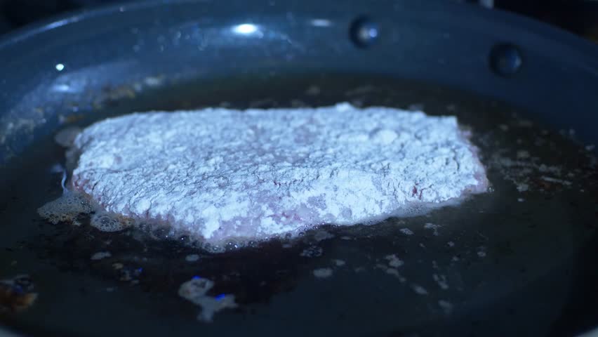 Country Fried Steak Cooking on Stove Top Close Up