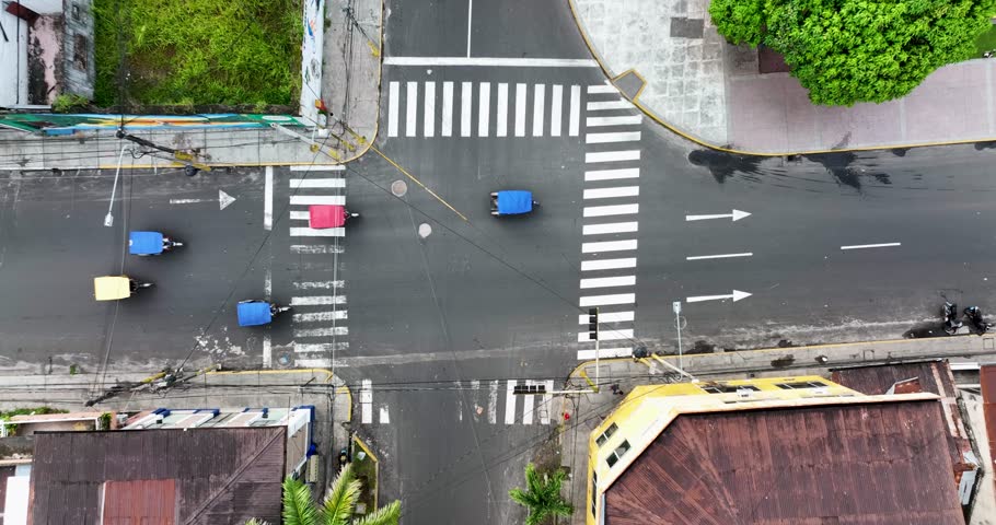 Aerial Drone fly view of moto taxi tuk tuk tuks and heavy traffic close to Belen market in Iquitos, Peru, South America. 4k High resolution video