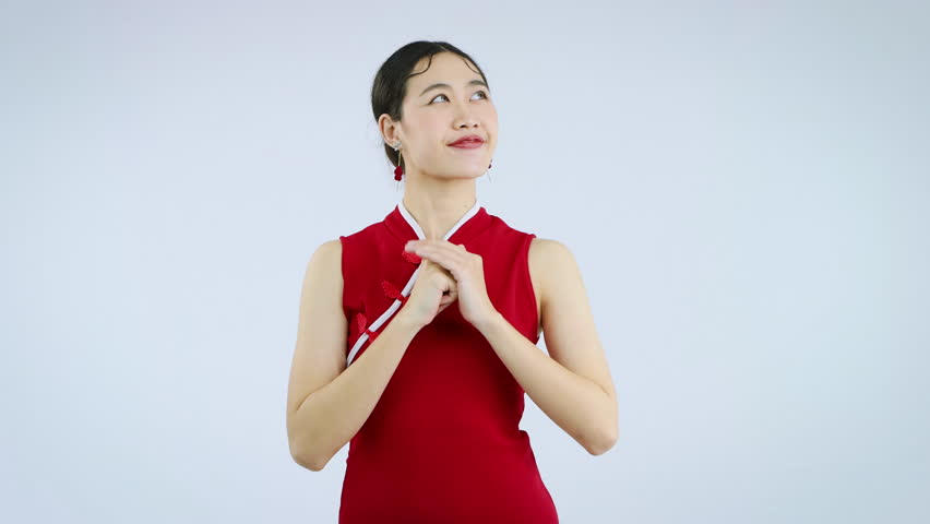 Asian beautiful woman in red traditional chinese dress wishing video 4K. Happy Chinese New Year Concept.