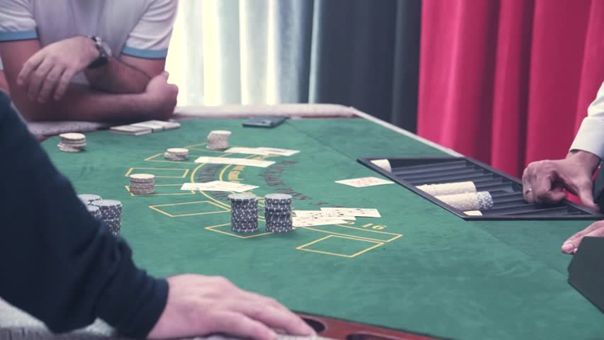 The gaming table in the casino, people making bets. There are money dollars and chips on the table. The concept of entertainment and luxury lifestyle. Casino gambling.