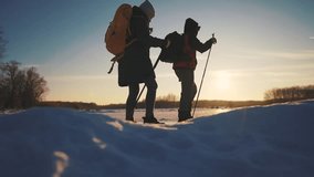 nordic walking in winter. winter hike group of tourists silhouette. teamwork travel. two hikers with sticks walk in the winter in the snow at silhouette sunset. activities in winter happy family - Powered by Shutterstock - Get 15% off with code: PIKWIZARD15