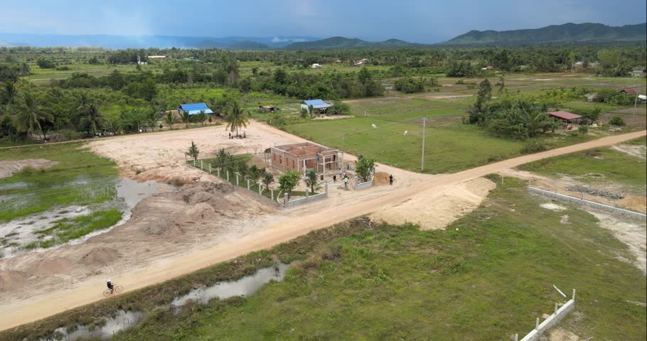 Aerial turning orbit shot revealing the home under construction in rural area   