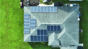 Ordinary residential house in USA with roof covered with solar panels for producing of clean ecological electricity in suburban rural area. Concept of investing in autonomous home for energy saving - Powered by Shutterstock - Get 15% off with code: PIKWIZARD15