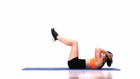 Young sportive girl lying on mat and training over white studio background. Press crunches exercise. Modern sport, action, motion, youth concept. Fitness, hobby, healthy lifestyle