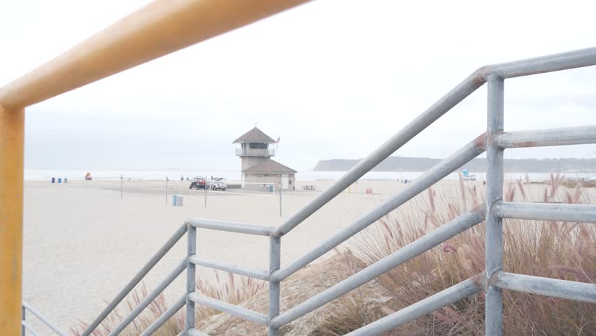 Lifeguard stand or life guard tower hut, surfing safety on California beach, USA. Rescue station, coast lifesavers wachtower or house, Coronado ocean beach, San Diego. Beach access stairs or steps.