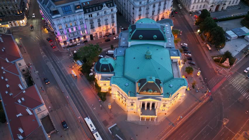 Vienna opera house at night, aerial night view of the capital of Austria, classic Vienna opera theatre with night illumination, downtown Vienna after sunset, tourism in Austria. 