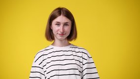 4k slow motion video of one girl posing for a video over yellow background.