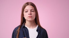 4k video of girl with thoughtful facial expression on pink background.