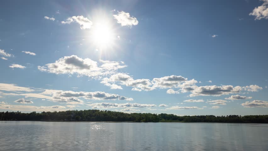 Time lapse of the clouds and sun moving above Pelican Lake in Orr, Minnesota.