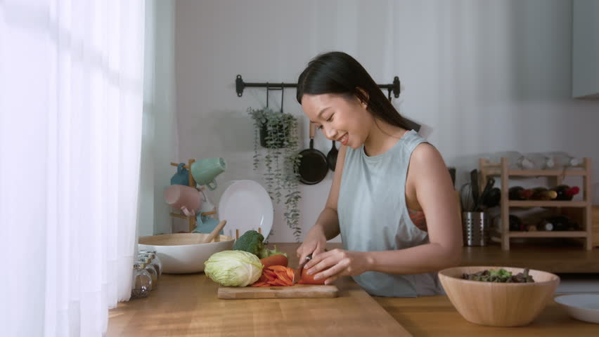 An Asian young woman cooking , preparing breakfast with healthy food in kitchen at home , healthy lifestyle

 Royalty-Free Stock Footage #1098483197