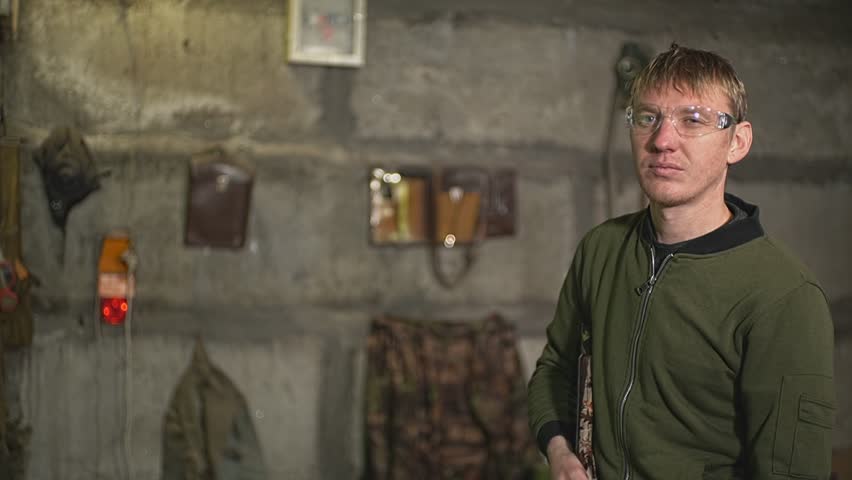 a man with glasses aims for shooting at a target on the wall. High-quality Full HD video recording. slow motion video