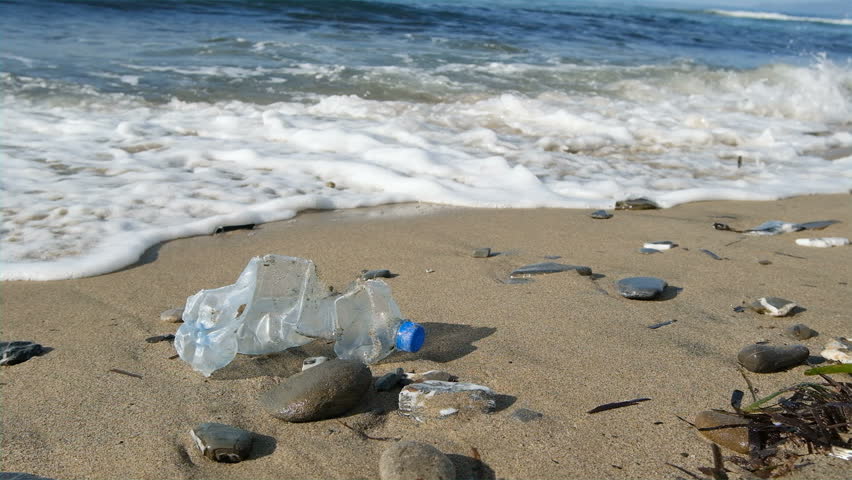 Discarded plastic bottle floating over sea waves on contaminated beach ecosystem, environment pollution, slowmotion Royalty-Free Stock Footage #1098486951