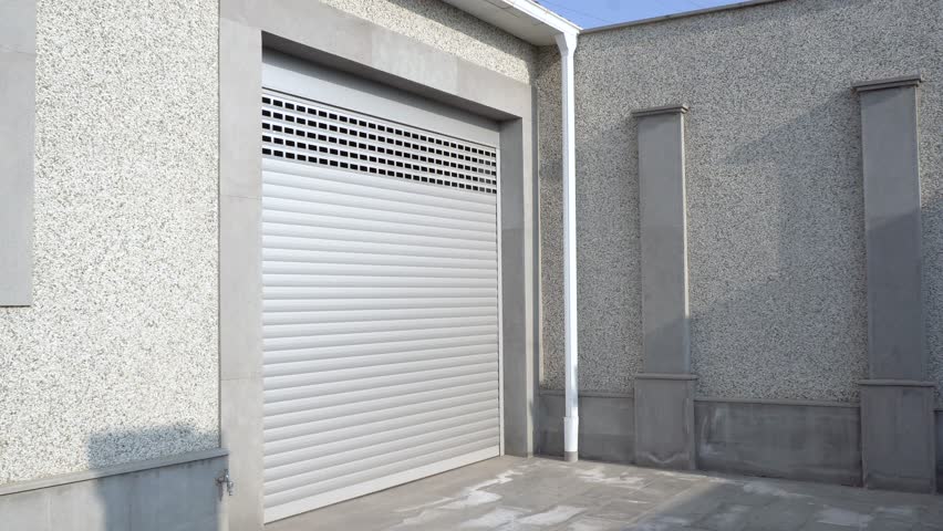Human hand opening roller shutter gate. Metal roller garage door as background. Automatic electric roll-up garage gate. Garage with rolling gates. | Shutterstock HD Video #1098494977