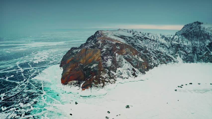 Lake Baikal, Olkhon Island, a flight of the Khoboy cape, with an aerial perspective in the background, going into the fog. A beautiful winter landscape. Overcast weather. Baikal, Siberia, Russia