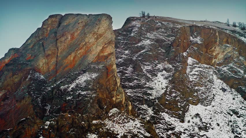 Lake Baikal, Olkhon Island, taking off over Cape Khoboy, the prospect of a large strait opens up. A beautiful winter landscape. Baikal, Siberia, Russia. Drone aerial shot 4k