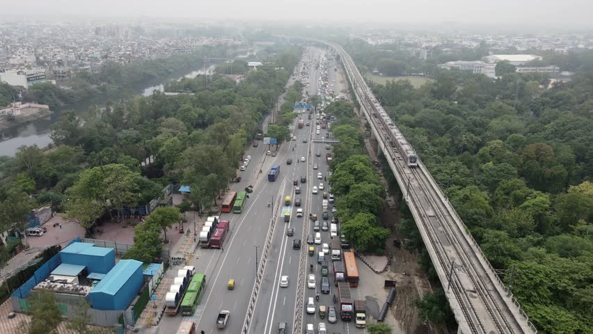 An aerial shot of Delhi Metro and road traffic along with Bharat Darshan Park,New Delhi India
