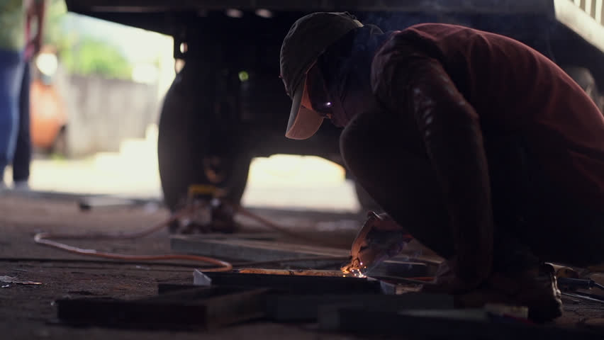 Man working in a workshop welding and using power tools and grinders  | Shutterstock HD Video #1098514287
