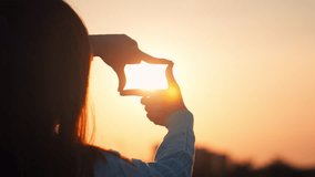 B roll - New year planning and vision concept, Close up of woman hands making frame gesture with sunset in winter, Female capturing the sunrise. - Powered by Shutterstock - Get 15% off with code: PIKWIZARD15