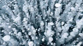 Frozen methane bubbles and cracks in the ice on Lake Baikal Siberia Russia. Natural cold background of ice. Winter abstract background. High quality 4k footage - Powered by Shutterstock - Get 15% off with code: PIKWIZARD15