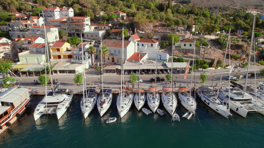 Sailing boats into the harbour of the Agia Effimia village on Kefalonia island, Ionian sea, Greece. Aerial view of the yachts moored in Agia Effimia marina, Cephalonia.