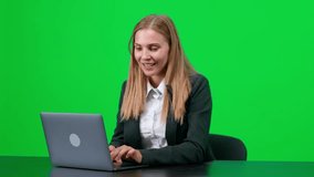 Cheerful businesswoman in a suit sitting at his desk and working on a laptop, the manager makes a good deal, green background, chromakey template. - Powered by Shutterstock - Get 15% off with code: PIKWIZARD15