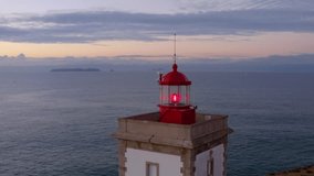 Coastal lighthouse. Calm and magical sunset at the picturesque cape. Aerial view of beautiful sunrise and light of the lighthouse. Aerial View of Lighthouse in Peniche, Portugal, and Cabo Carvoeiro. 