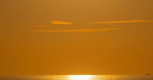 Time lapse of Majestic sunset light over sea landscape,Amazing light of nature cloudscape sky and Clouds moving away rolling, Colorful sunset or sunrise light dramatic clouds in golden hour Footage