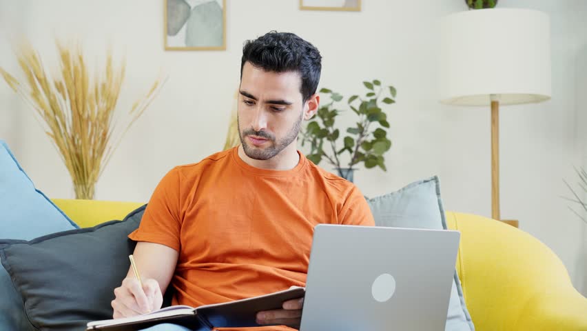 Smiling man using laptop in living room | Shutterstock HD Video #1098548337