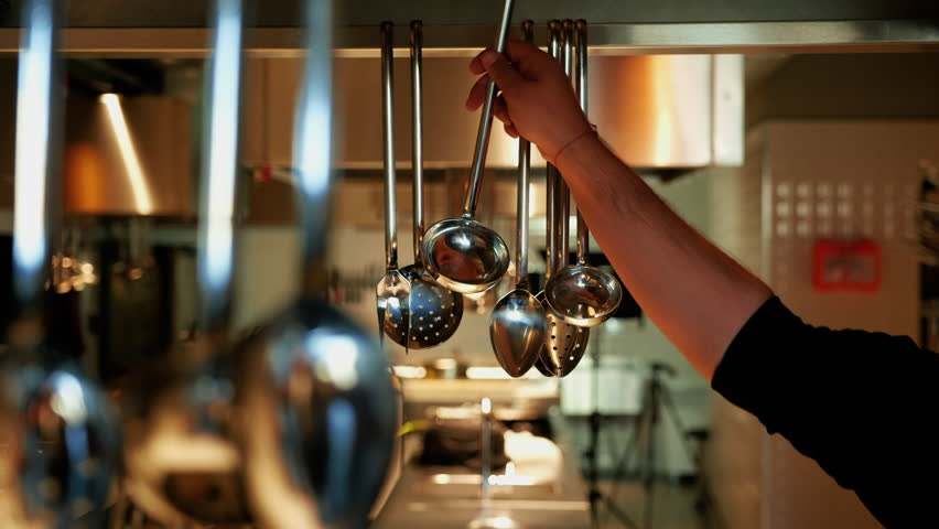 Chef in professional kitchen is buying equipment for cooking. Food industry