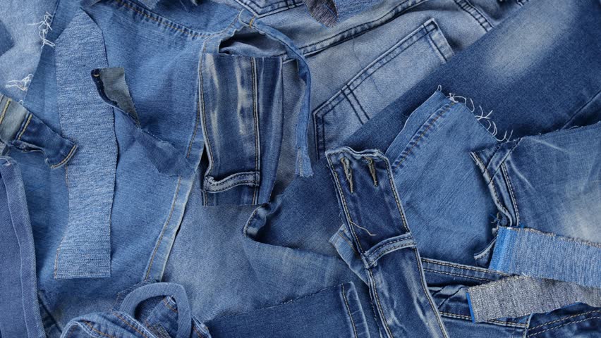 Denim fabric scraps. Recycling and upcycling jeans waste. Cutting the garment from the fabric will always generate some waste. Quilting Fabrics Royalty-Free Stock Footage #1098552507