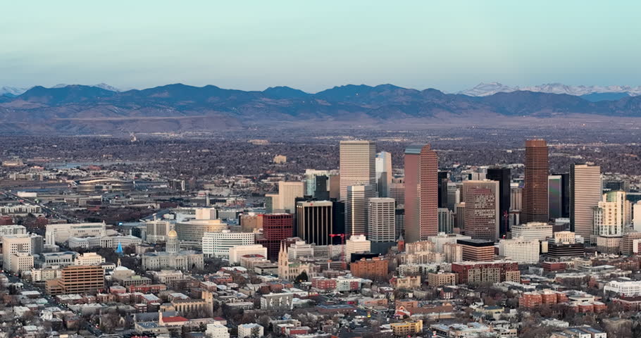 Aerial panorama of downtown Denver. Mountains with snow in the background