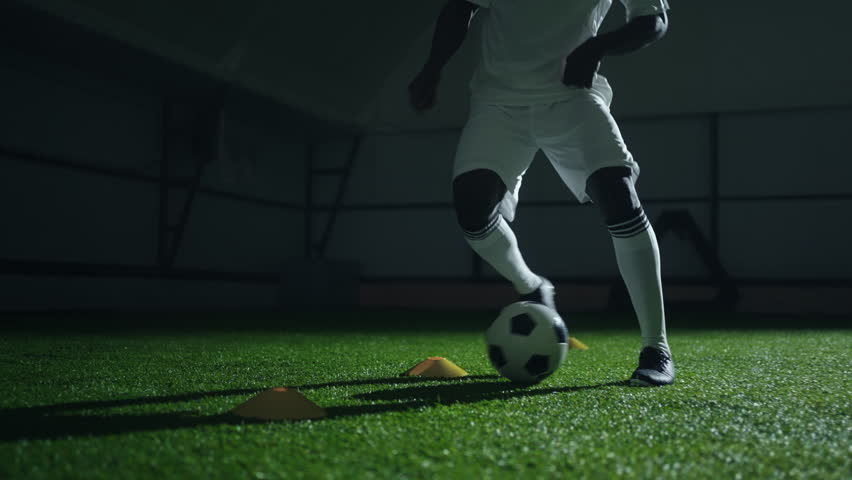 african football player training in hall, running with ball, kicking and dribbling, closeup view - Powered by Shutterstock - Get 15% off with code: PIKWIZARD15