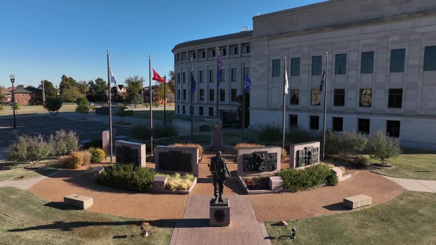 Flags of USA military on grounds of Oklahoma City capitol honors veteran soldiers. Aerial view.