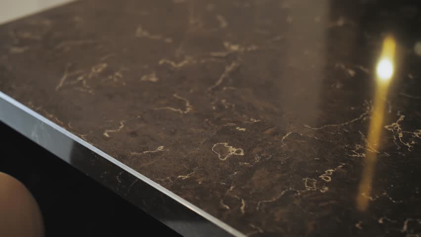 Close-up shot of beautiful granite black counter top, camera moving slow motion. Kitchen design with counter top made of granite stone. Royalty-Free Stock Footage #1098560821