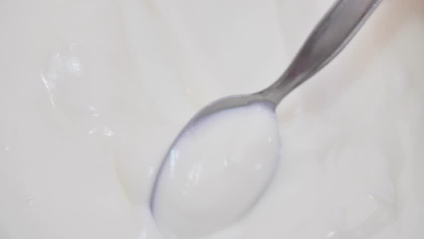 Shooting of bowl with stirred yoghurt and spoon | Shutterstock HD Video #1098561409