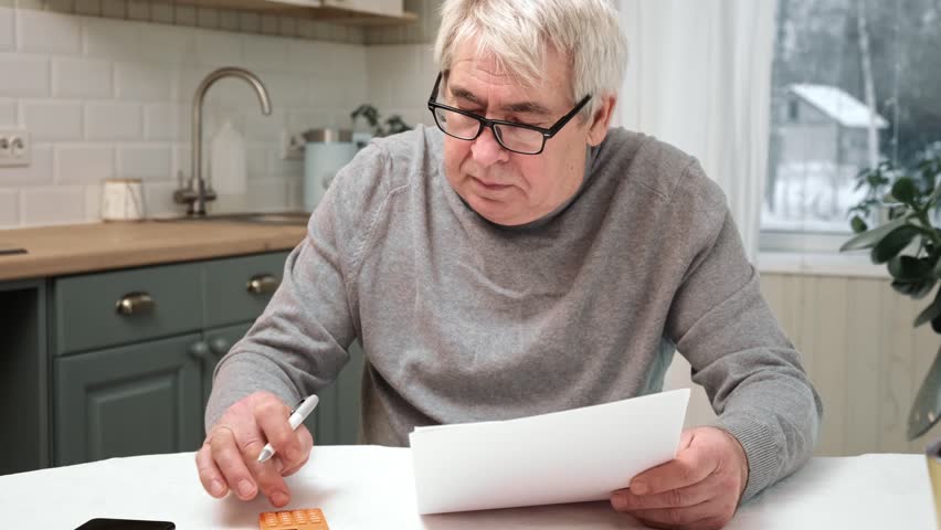 Senior Man Checking Calculating Personal Finance at Home, Feeling Stress from Money Problem. Concerned Elderly Male get Official Bank Notification, Financial Bill, Unpaid Debt or Tax and Feel Worried | Shutterstock HD Video #1098562733