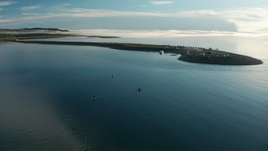 Aerial view of a man paddling a boat on the lake