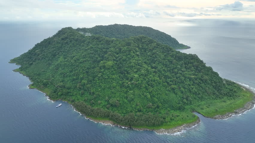 Rainforest covers the remote Mary Island which is fringed by a coral reef in the Solomon Islands. This beautiful country is home to spectacular marine biodiversity and many historic WWII sites. Royalty-Free Stock Footage #1098567201
