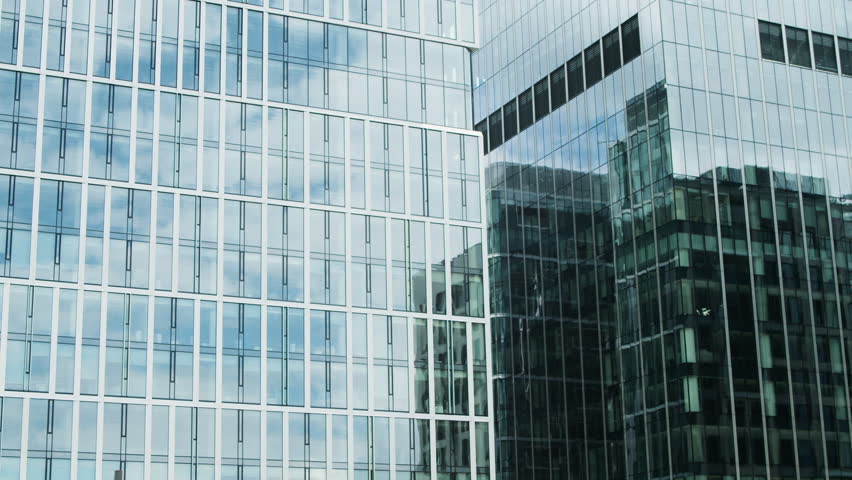 Time lapse White clouds reflected in the glass office windows of a skyscraper in the financial center of Toronto. Time lapse of clouds in office windows business center building in the city center.  | Shutterstock HD Video #1098569183