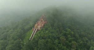 Aerial View at Morning Wat Phra That Doi Phra Chan. and Daibutsu Buddha on the mountain at Lampang Province Thailand 4k video from Drone.
