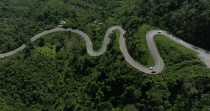 aerial view ROAD No.1081 beautiful curve winding mountain road between Pua District,Nan Province, Northern of Thailand is check-in point and landmark that tourist shooting photo,4k video aerial view,
