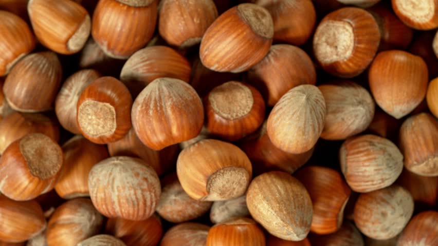 Super slow motion of rotating hazelnuts up to the air. Filmed on high speed cinema camera, 1000fps, placed on high speed cine bot. Speed ramp effect. Royalty-Free Stock Footage #1098573547