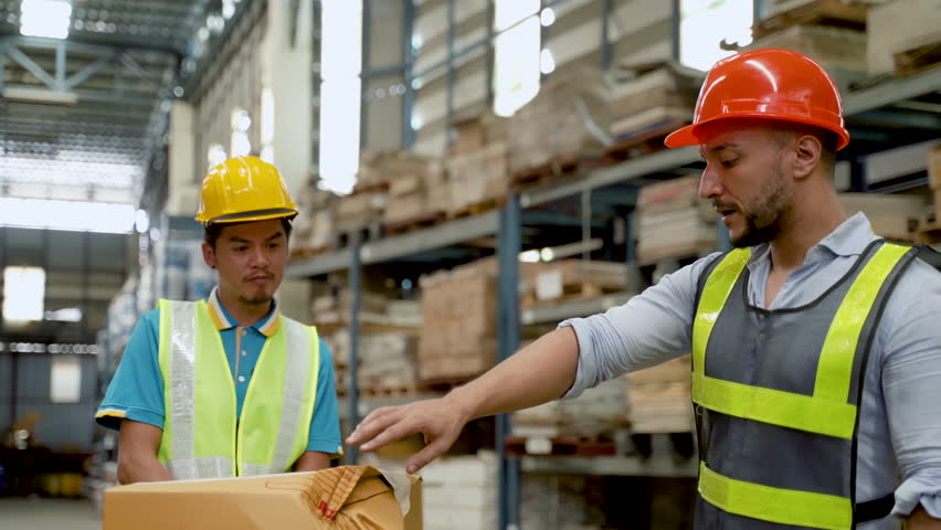 4K, supervisor stood and pointed out defective point product box, for his employees see, along with informing and admonishing employees not bring damaged goods from this warehouse in the shelf. Royalty-Free Stock Footage #1098573907
