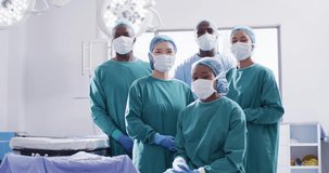 Video portrait of diverse group of surgeons ready for surgery in operating theatre. Hospital, medical and healthcare services.