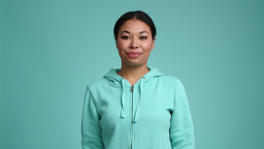 Portrait of young woman holding fresh citrus fruit and smiling. Close-up view of a cheerful, young girl smelling yellow pomelo. High quality 4k footage