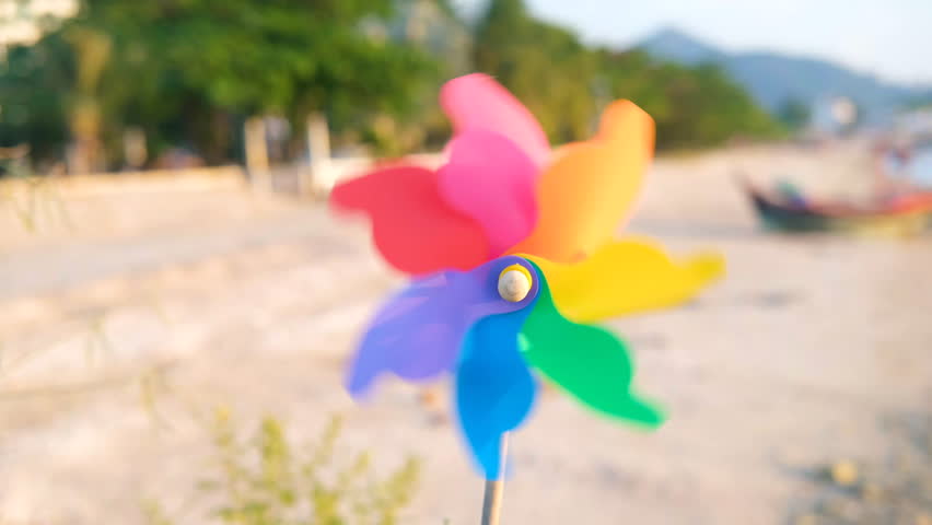 man hand holding turbines windmills on sky object for freedom, kid, windmills air childhood child motion lifestyle park play and vacation travel toy