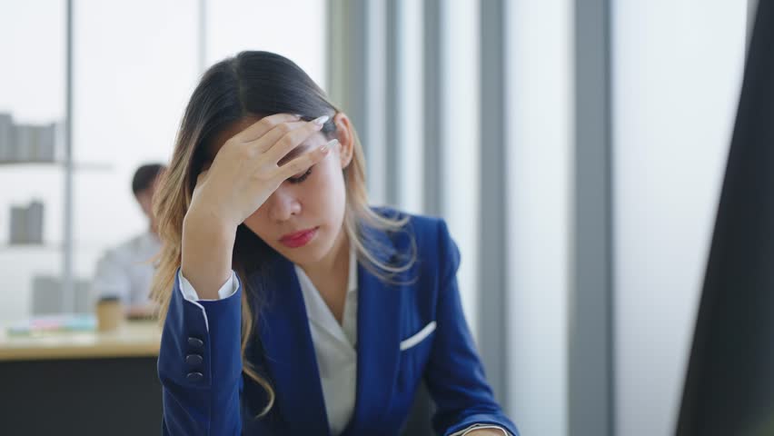 Close up exhausted face of employee woman stressed unhappy feeling sitting and working on desk at office | Shutterstock HD Video #1098592457